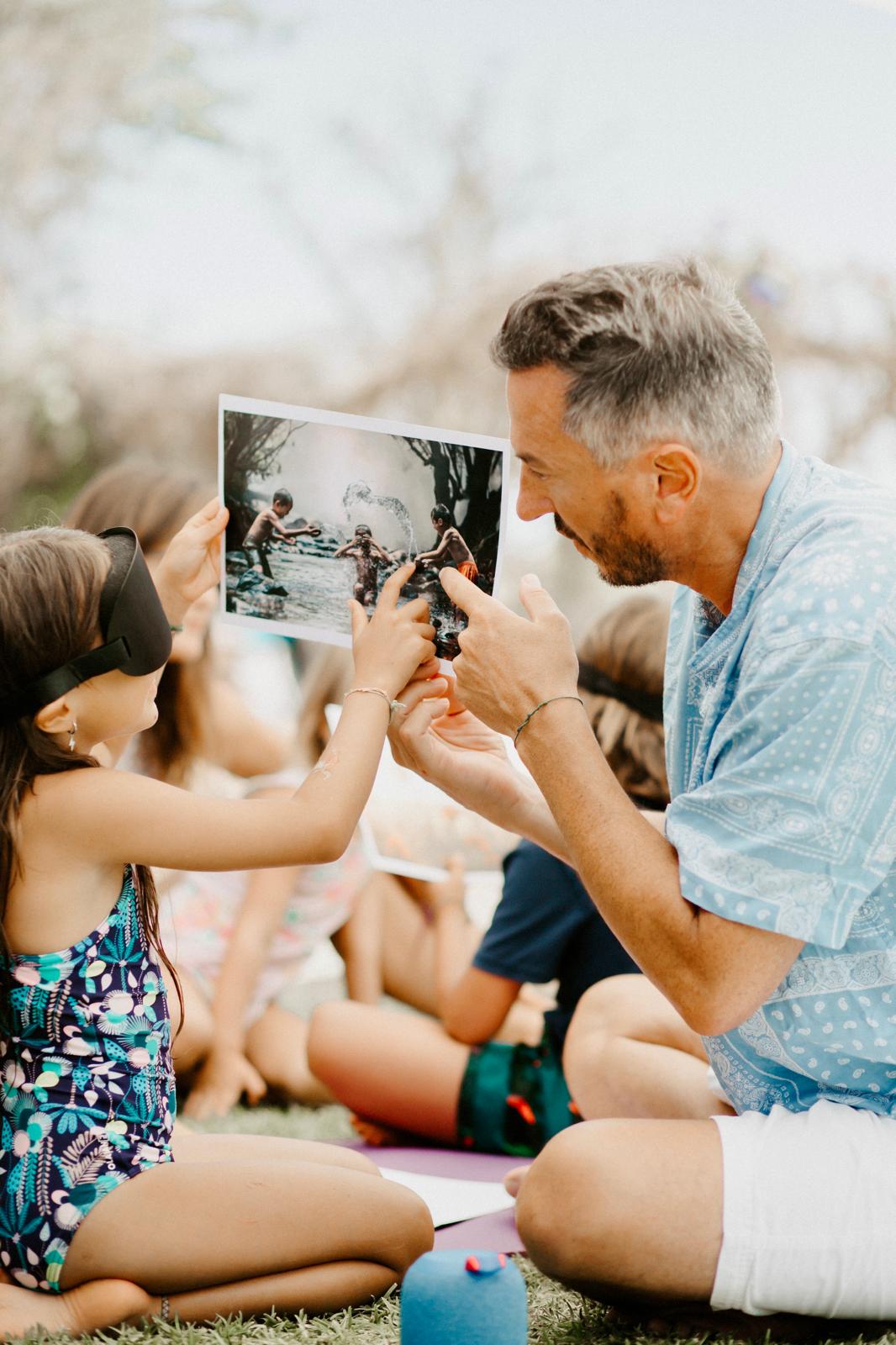 A facilitator and a blindfolded child exploring intuitive perception with a printed image