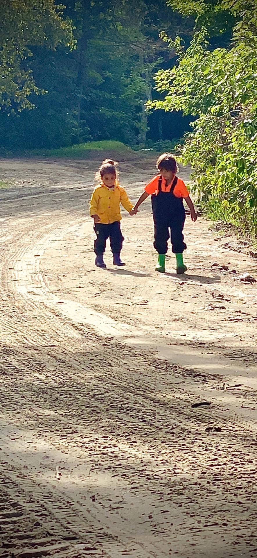 Children walking together on a winding road — the path ahead, growth, and exploration
